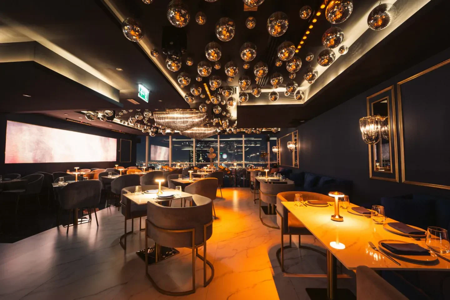 Stylish interior of 53 Dubai restaurant with disco ball decor and city views in Dubai.