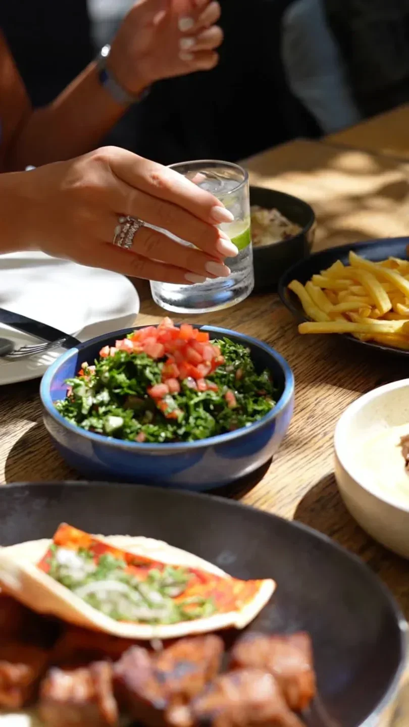 Table setting at Abd el Wahab Dubai with appetizers and a refreshing drink.