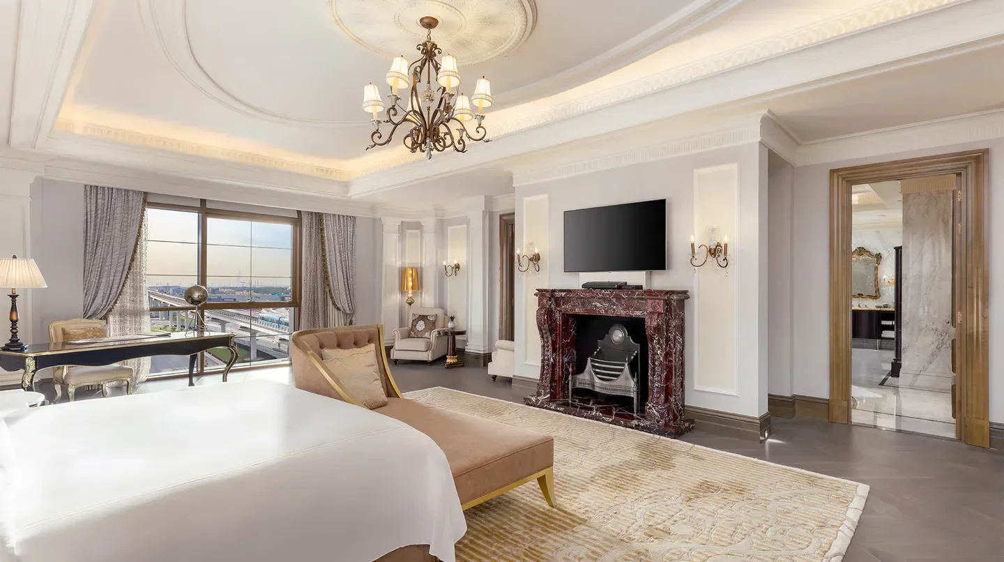 Luxury hotel suite at Al Habtoor Palace in Dubai, featuring elegant decor and city views.