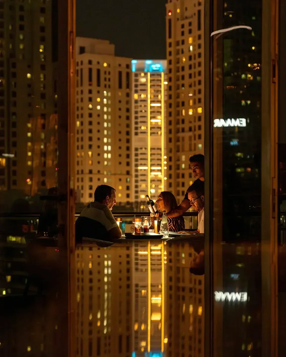 Dining at Atelier M in Dubai, with a view of the city skyline at night.