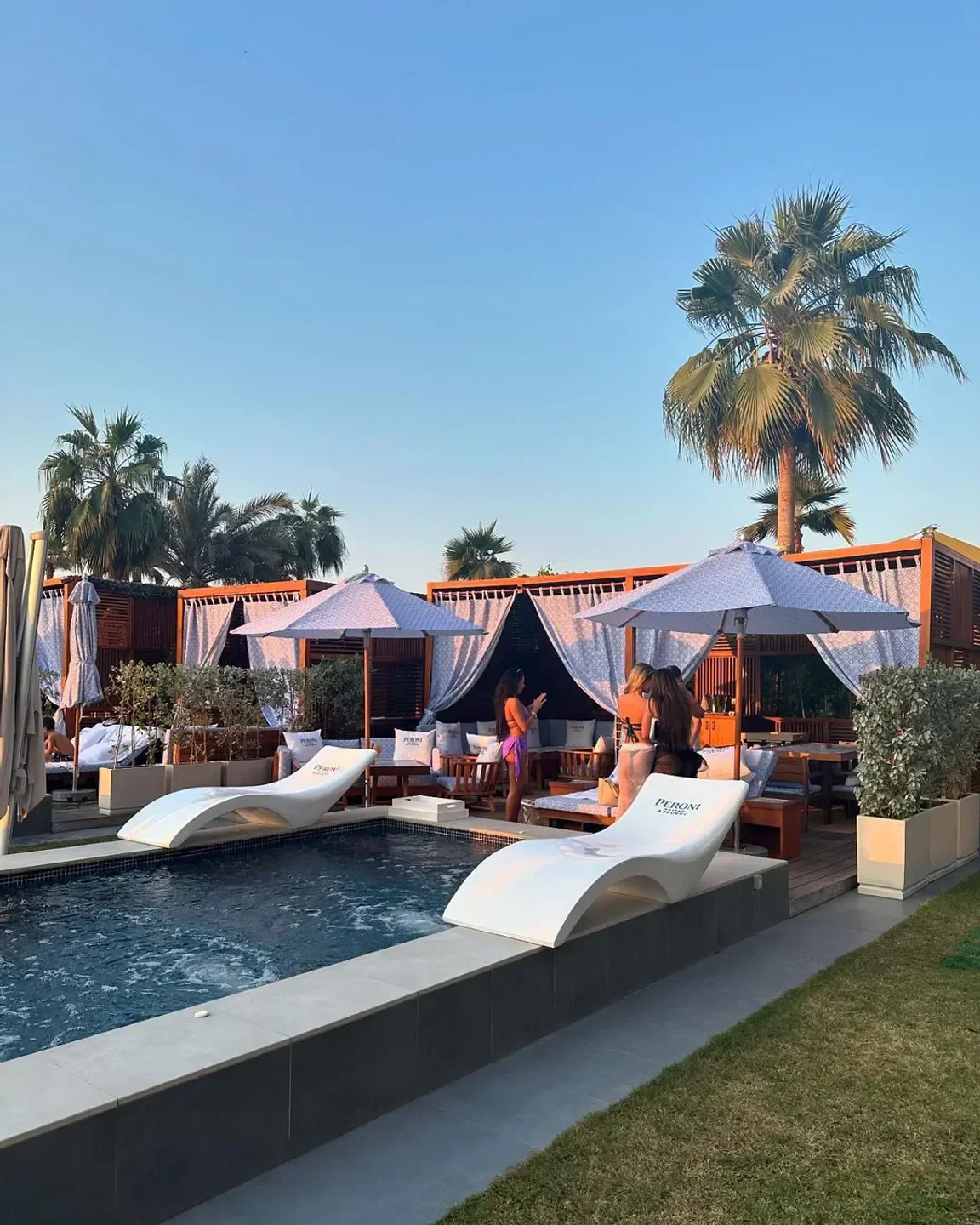 Azure Beach Dubai, a stylish beach club with a pool, loungers, and cabanas.