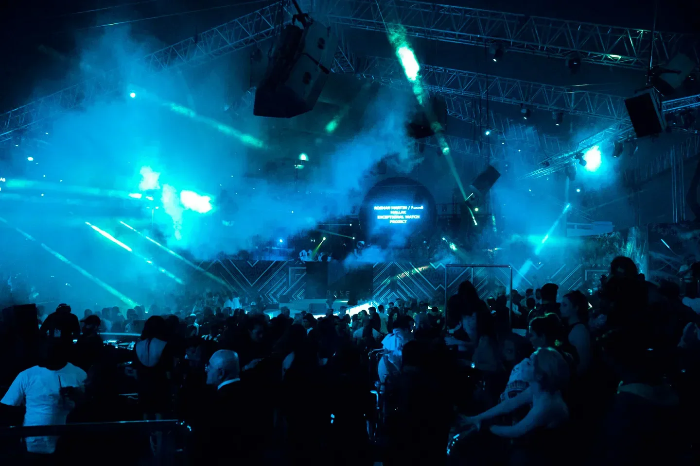 Energetic atmosphere at BASE nightclub in Dubai with crowd and vibrant lighting