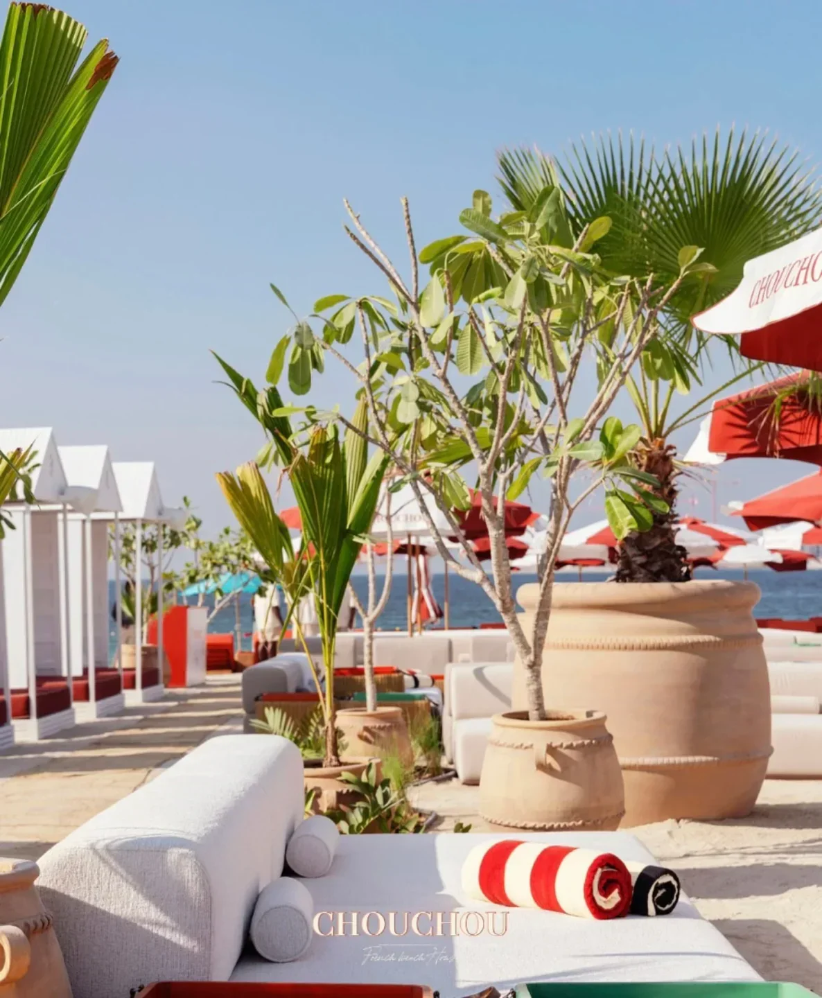 Chouchou Dubai beach restaurant, featuring cabanas, potted plants and beachside lounge areas.