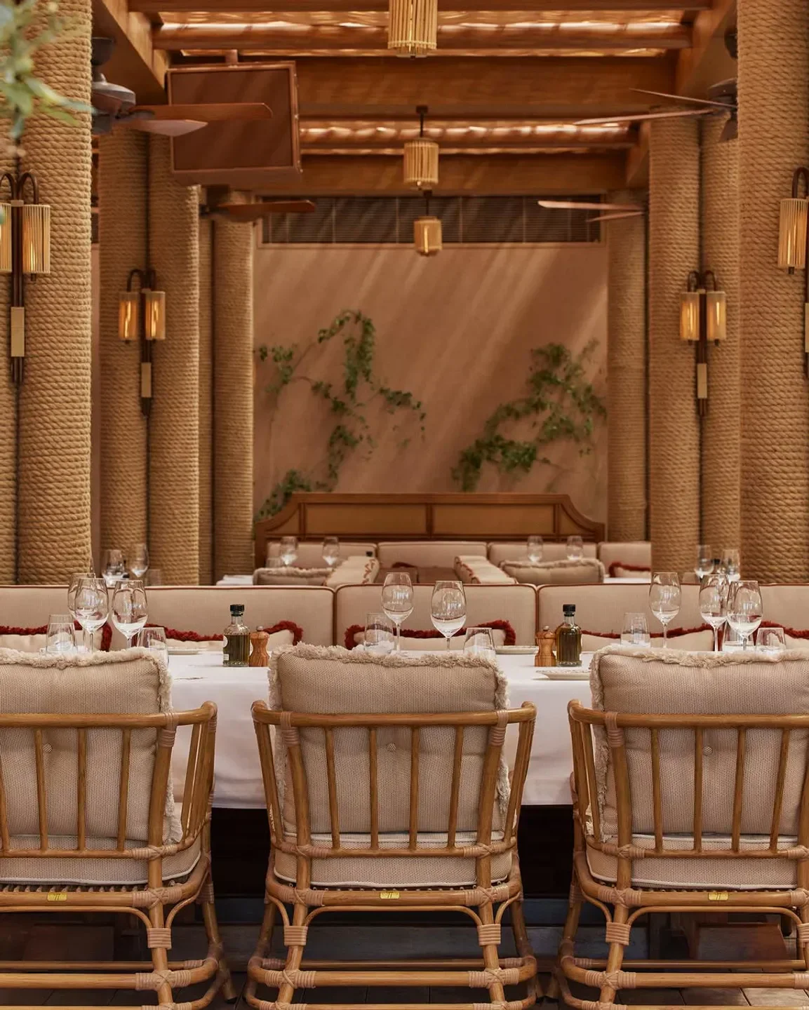Elegant dining area at Gigi Rigolatto Dubai, featuring stylish rattan chairs and table setting.