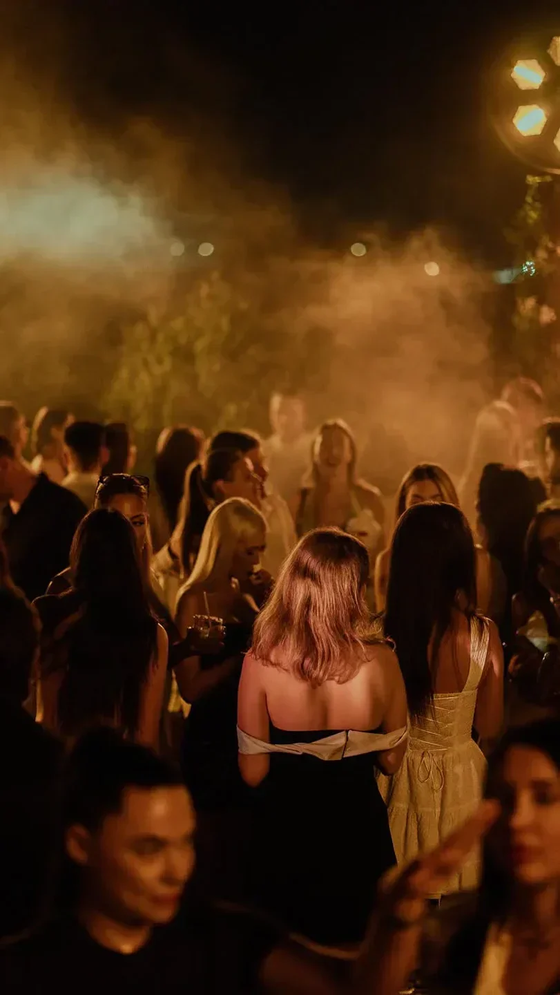Nightlife scene at Gigi Rigolatto Beach Club in Dubai, with a crowd of people partying.