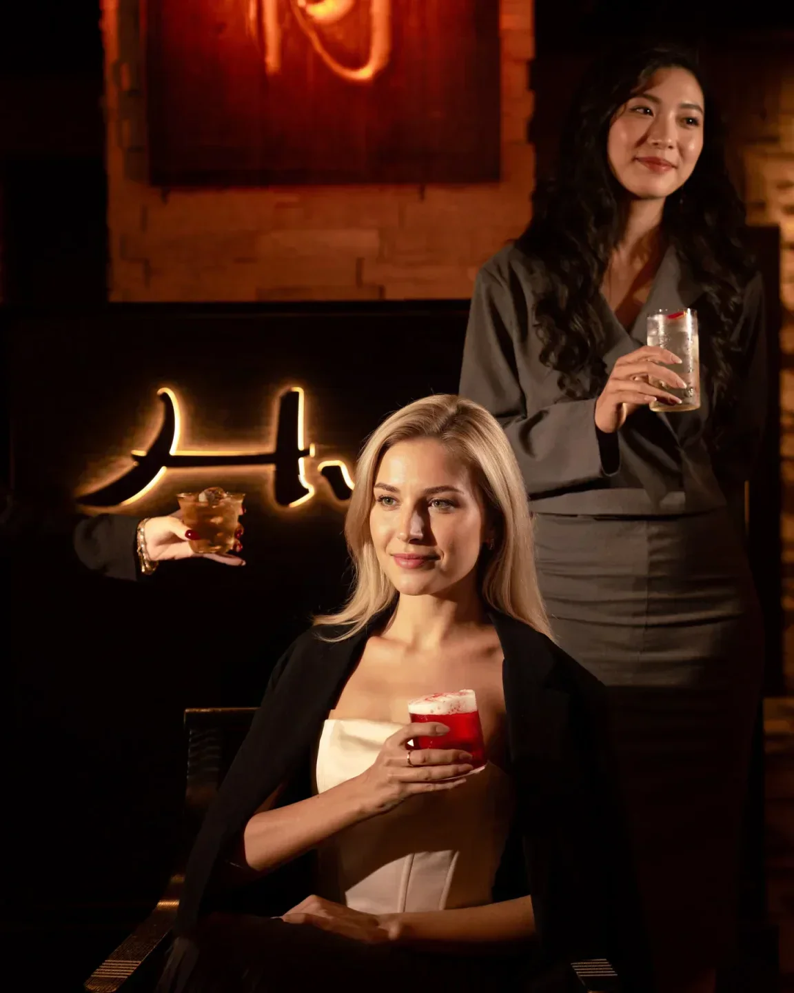 Stylish interior with guests at Hutong Dubai, enjoying cocktails and a luxurious ambiance.