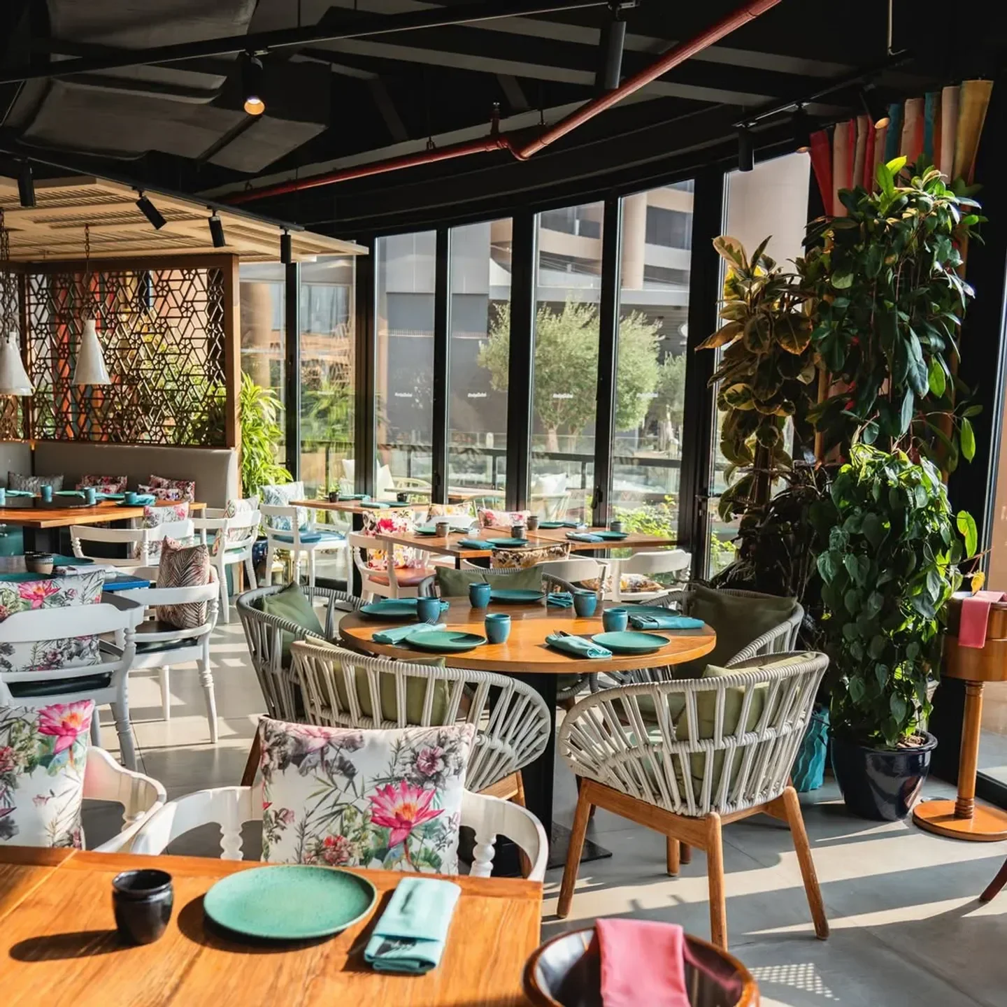 Elegant interior dining at Indya by Vineet in Dubai, featuring floral decor and vibrant seating.