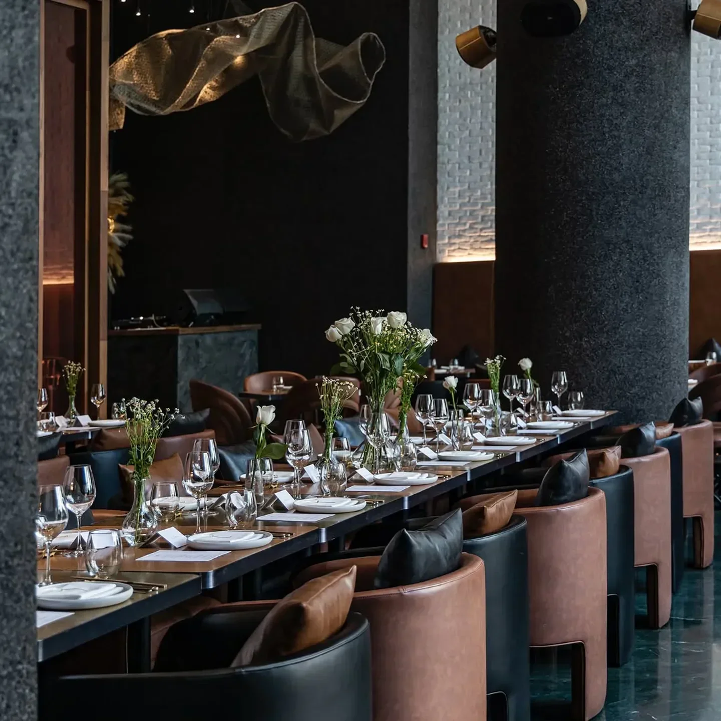 Elegant dining at Jun's restaurant in Dubai with tables set and decor.