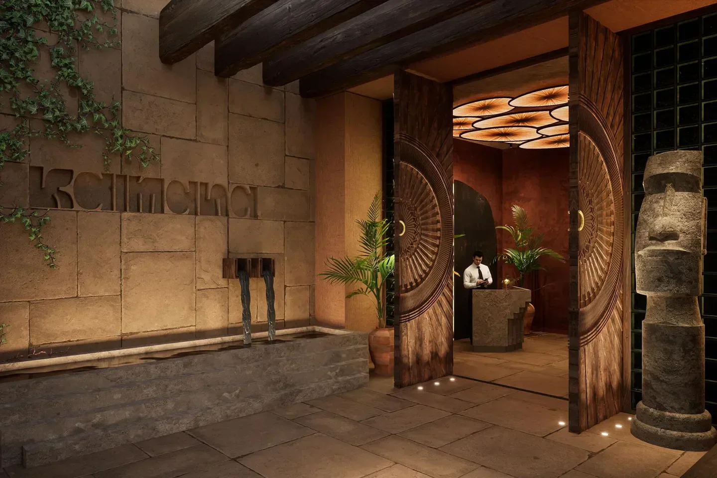 Entrance of Kaimana Beach Club in Dubai with stunning carved doors and water feature.