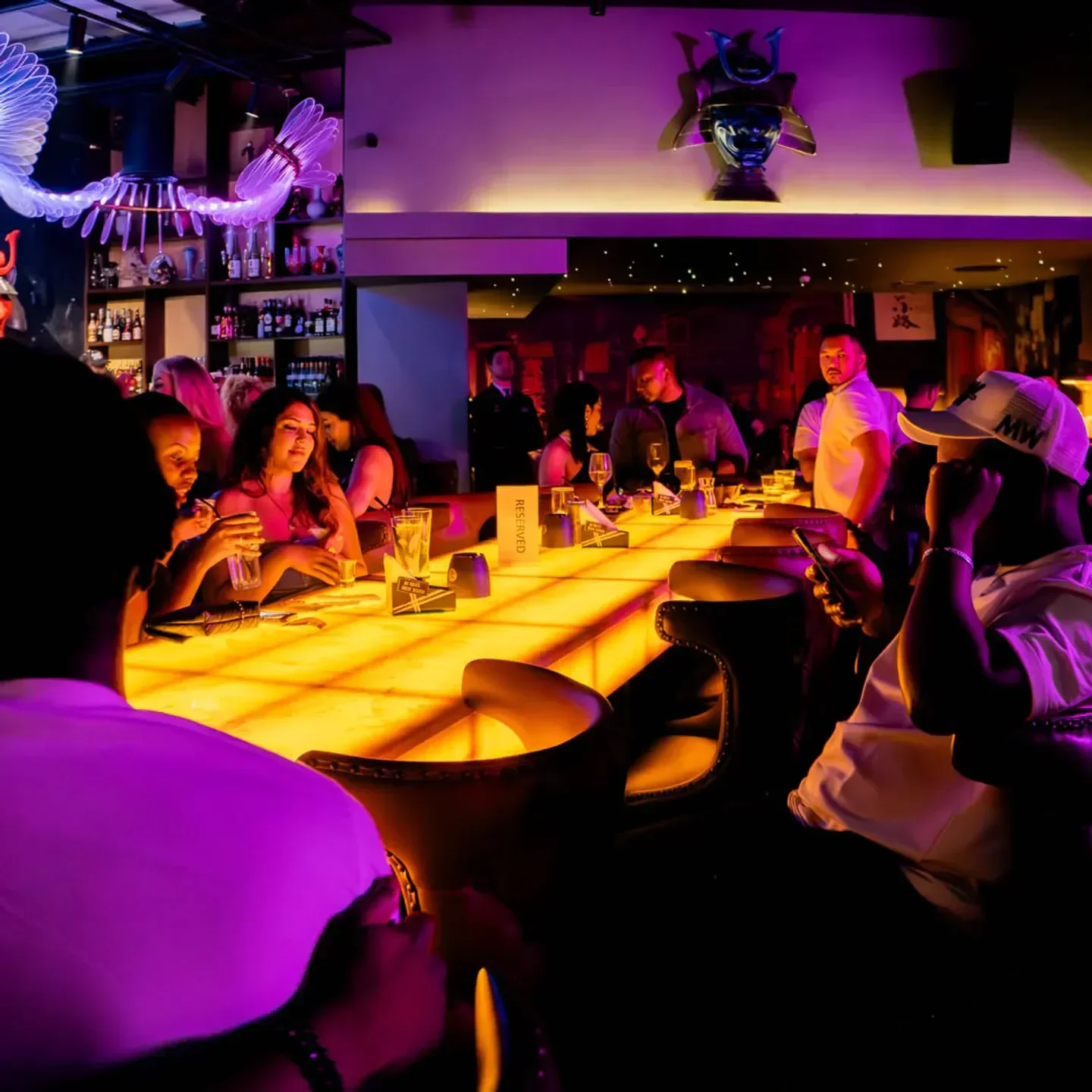 Inside Kanpai Dubai restaurant with people at the bar, enjoying the nightlife.