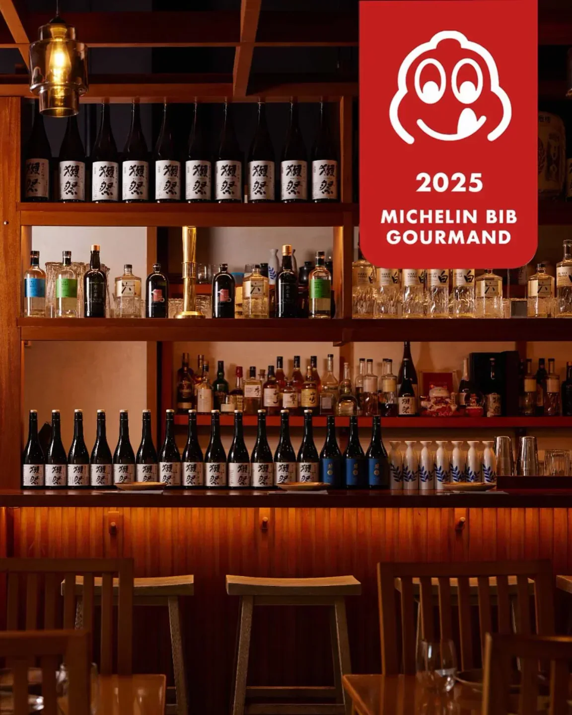 Interior of Kinoya Dubai, showcasing shelves of sake and spirits with Michelin Bib Gourmand.