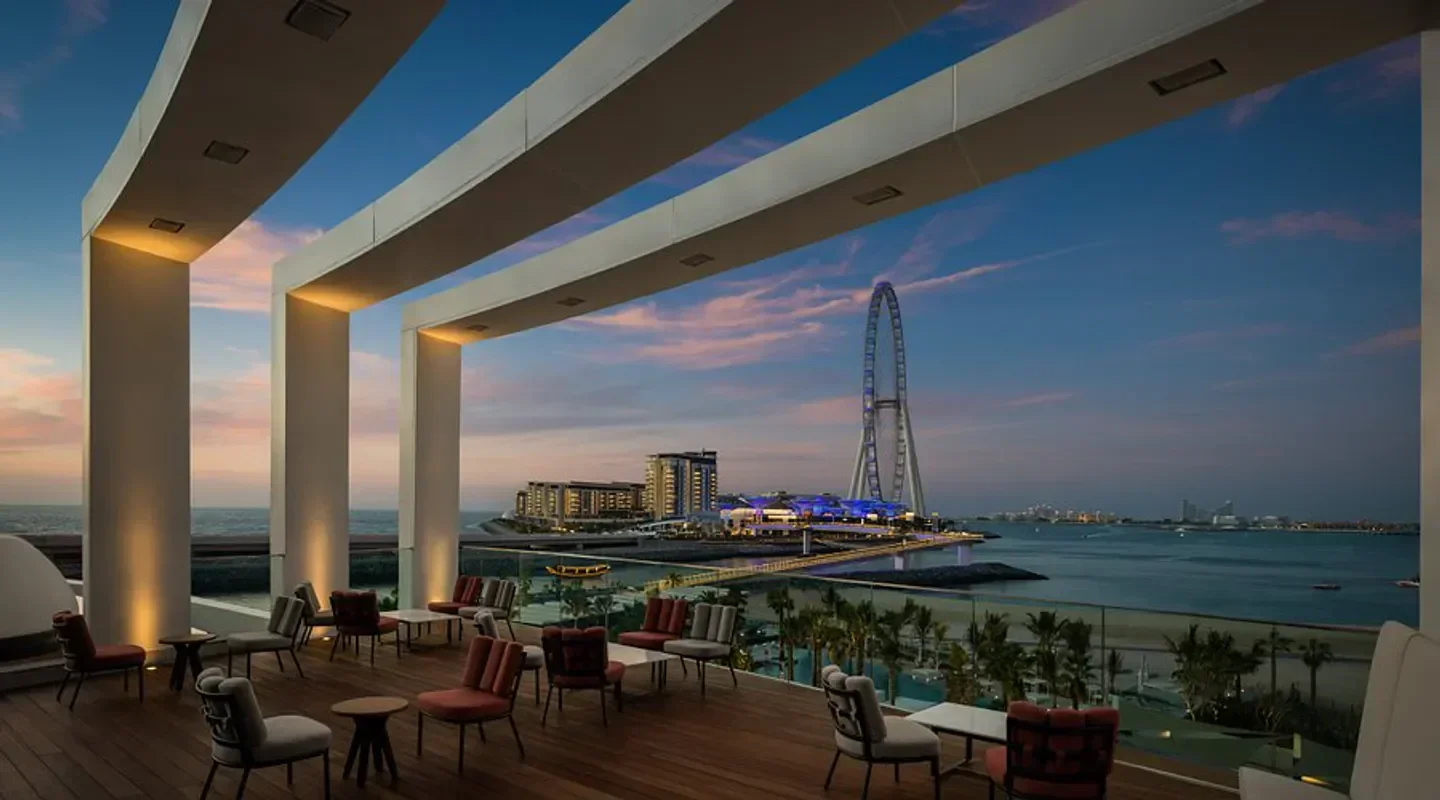 LiBrasil Dubai restaurant terrace with skyline views at sunset, featuring the Ain Dubai