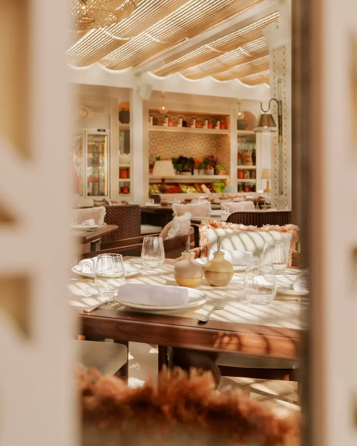 Elegant table setting at Maison de la Plage in Dubai, featuring a bright, airy dining space