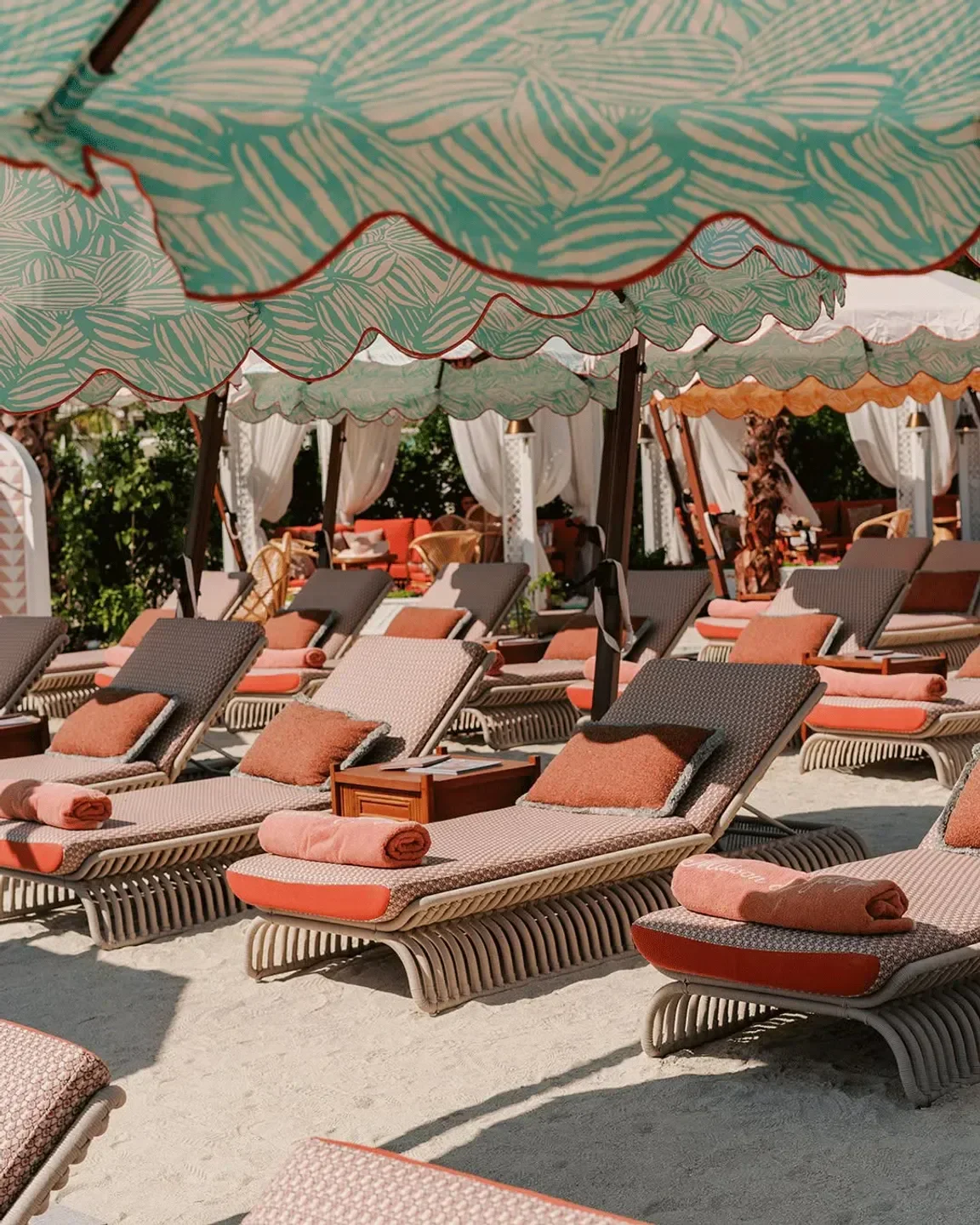 Relaxing lounge chairs at Maison de la Plage Dubai beach club, under stylish canopy