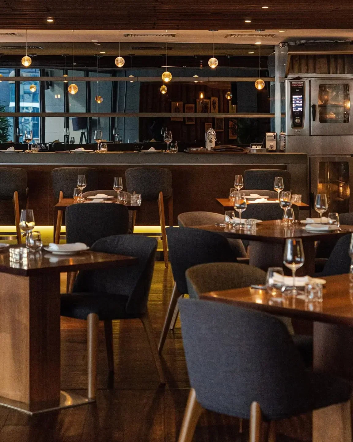 Interior of Marina Social Dubai restaurant with tables, chairs, and bar