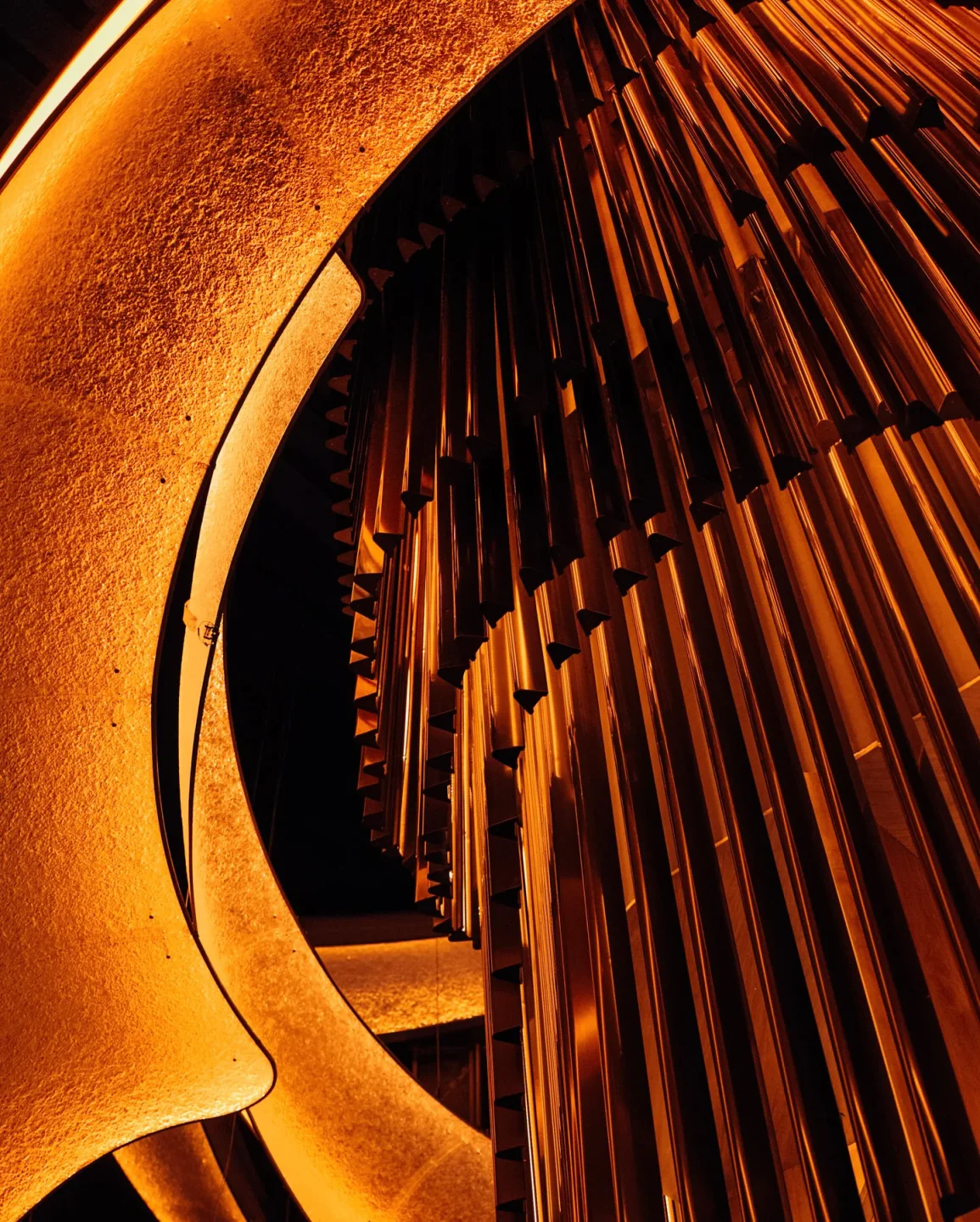 Warm ambient lighting highlights the textured architectural details at Nobu One Za'abeel restaurant.