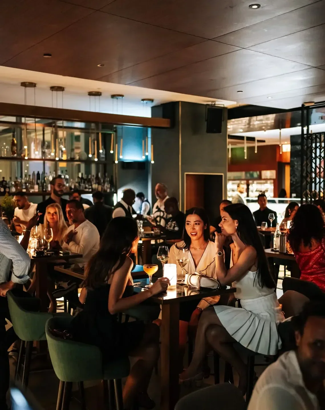 Elegant dining scene at Roberto's Ristorante in Dubai, featuring guests and cocktails.