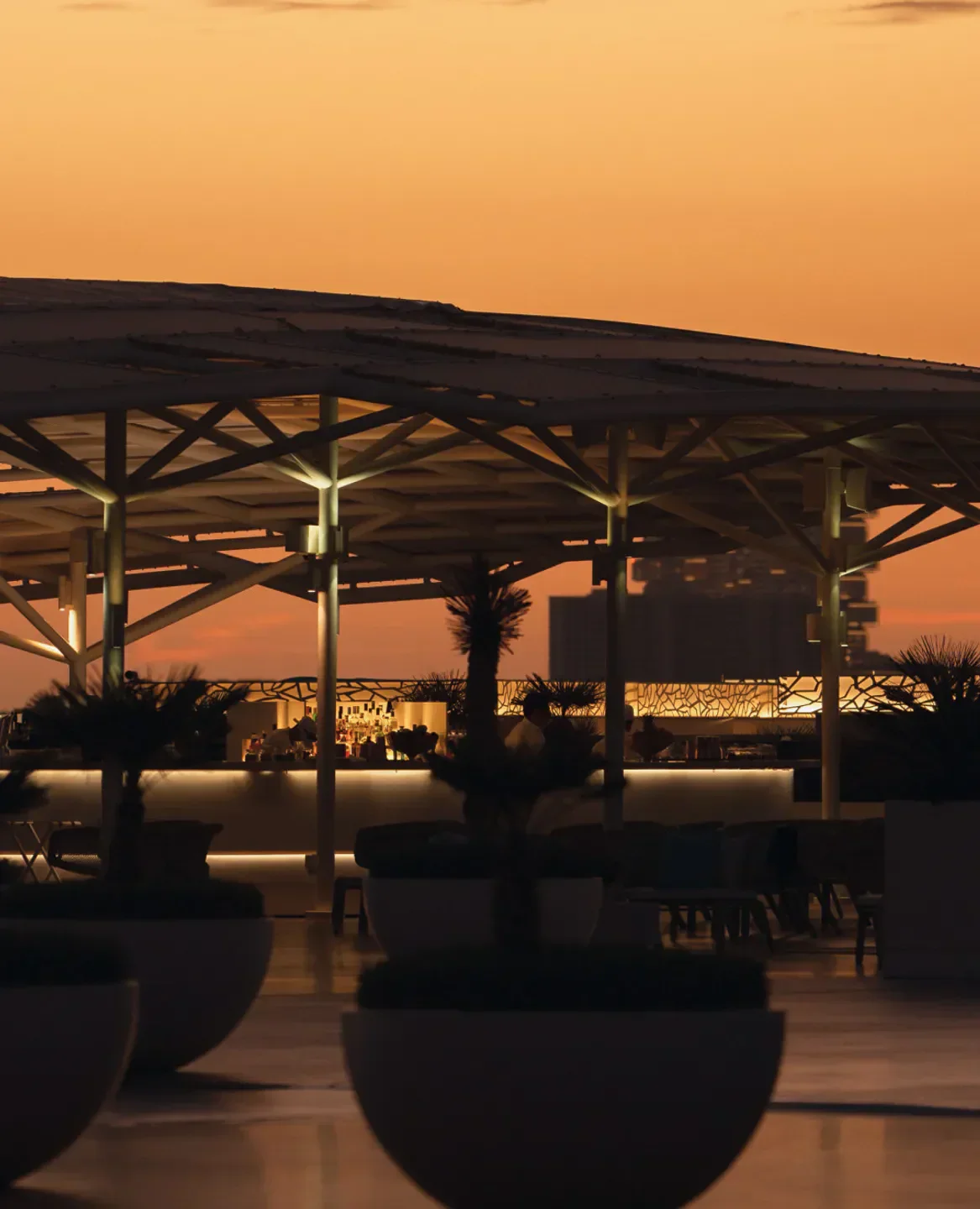 Rooftop bar at SAL Dubai with a sunset view and stylish design.