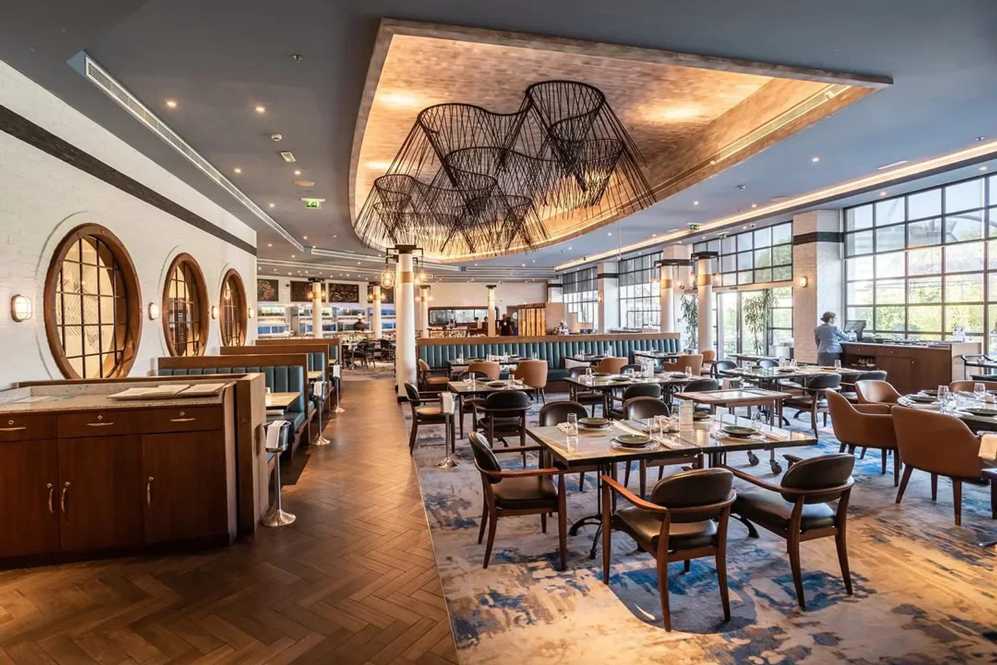 Seafood Market Dubai restaurant interior. Dining tables with elegant lighting and modern decor.