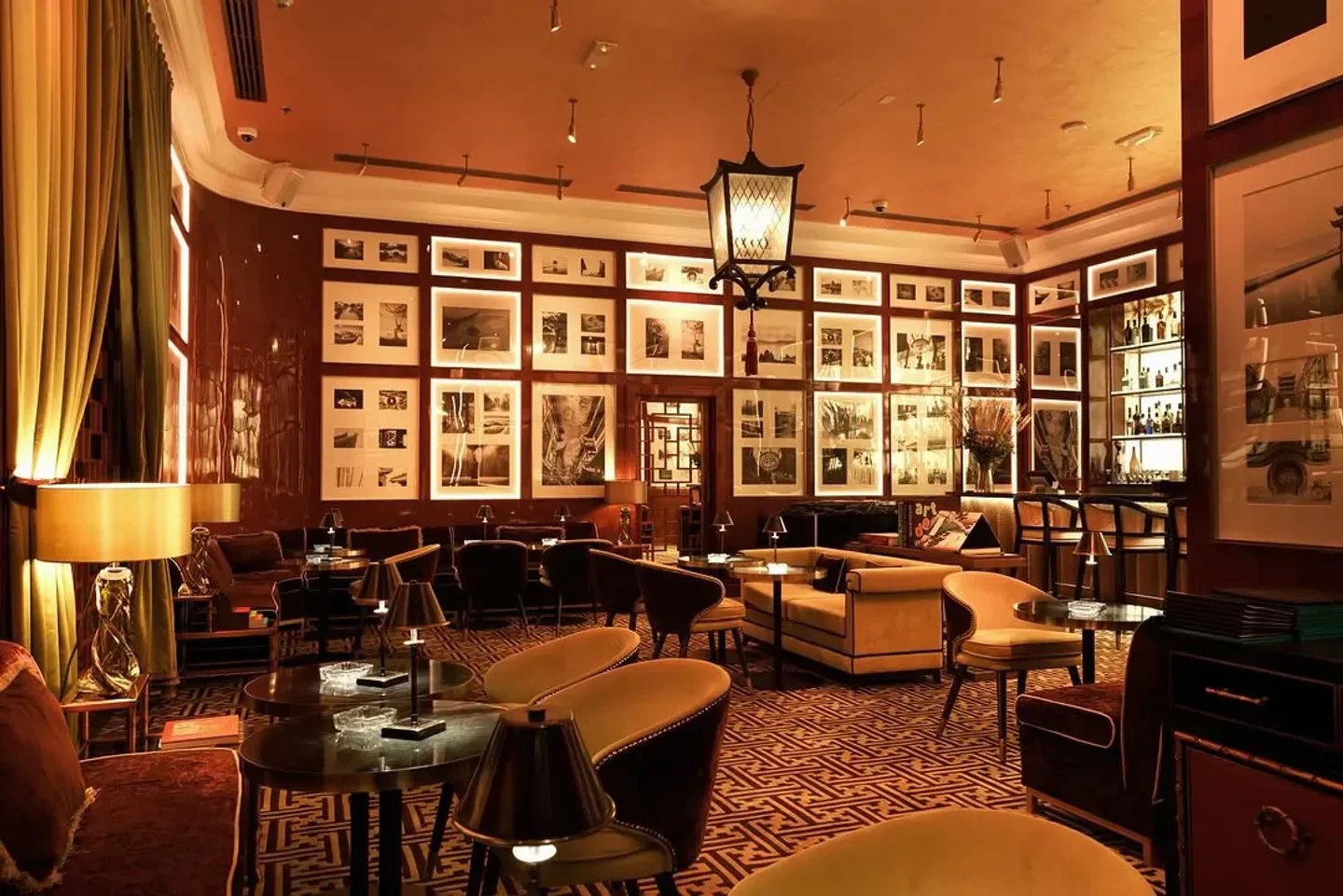 Interior of Shanghai ME restaurant in Dubai, featuring elegant seating and wall art.