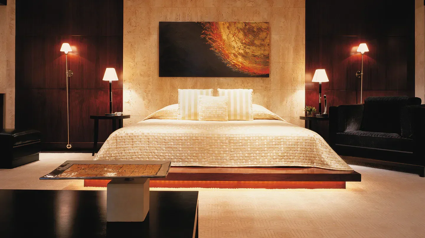 Luxury bedroom at Shangri-La Hotel, Dubai, with art, lamps, and a comfortable bed.