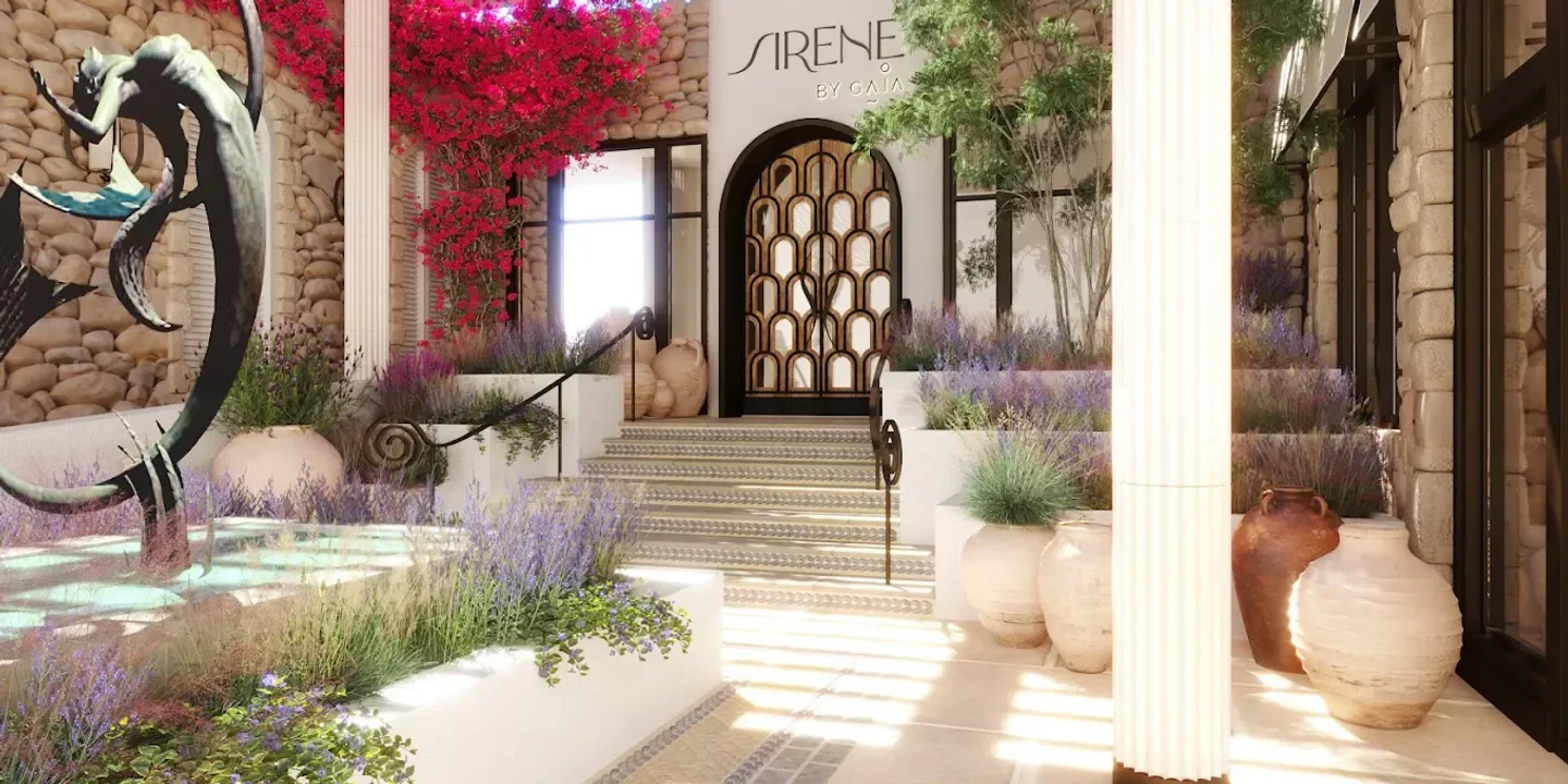 Entrance to Sirene by Gaia in Dubai, featuring a mermaid statue and stylish architecture.