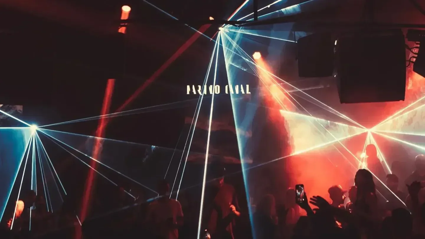 Energetic nightclub scene at SOHO Garden Dubai, with vibrant laser lights and dancing crowd.