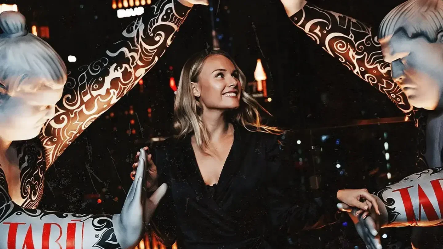 Woman at Tabu Dubai nightclub with artistic decor, enjoying the nightlife.