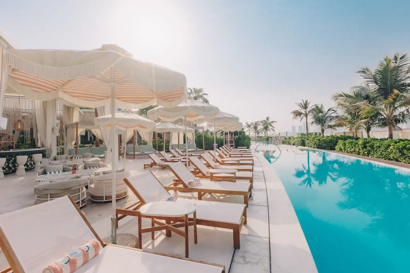 The 305 Dubai beach club in Dubai with sun loungers and a stunning pool view.