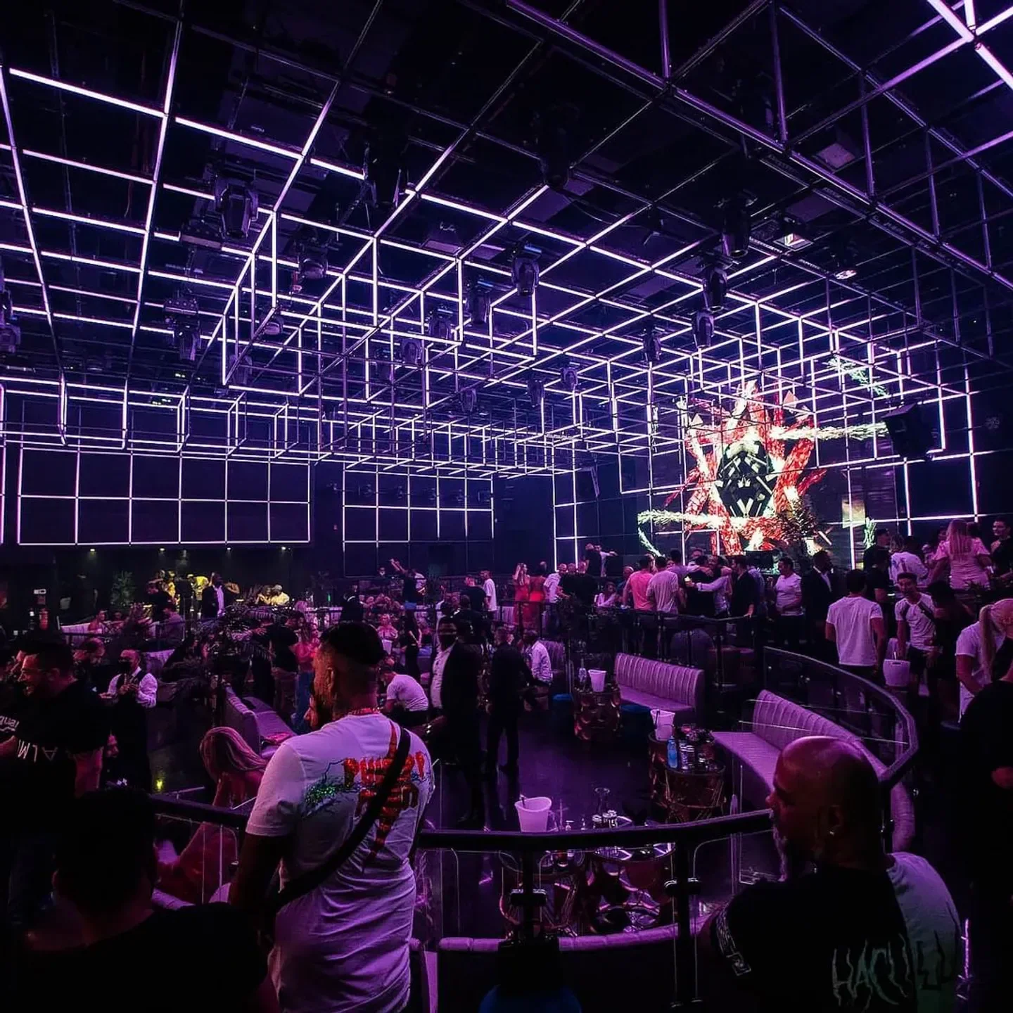 Inside The Avenue Club Dubai: purple neon lights and a lively crowd enjoying the nightlife.