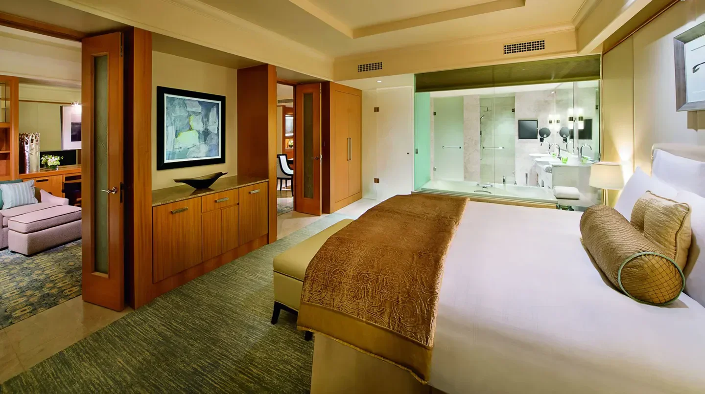Luxury bedroom at The Ritz-Carlton, Dubai International Financial Centre, Dubai, with ensuite bathroom.