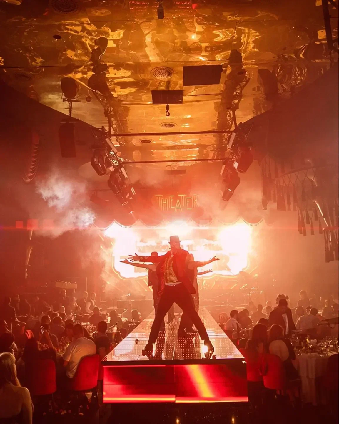 Spectacular performance at the Theater in Dubai, featuring dancers and a lively crowd.