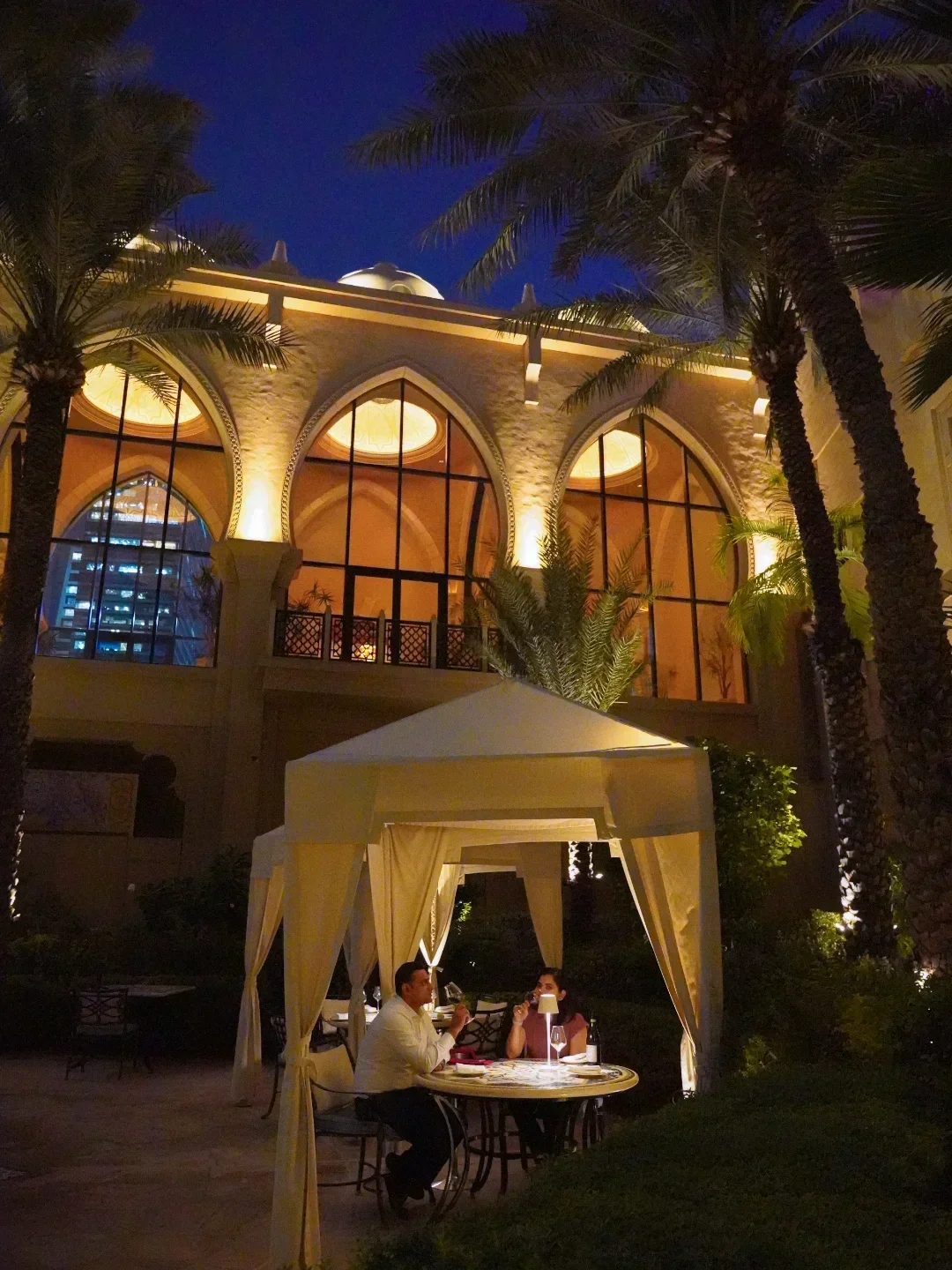 Romantic outdoor dining at Tresind Dubai, featuring a canopy and elegant architecture.