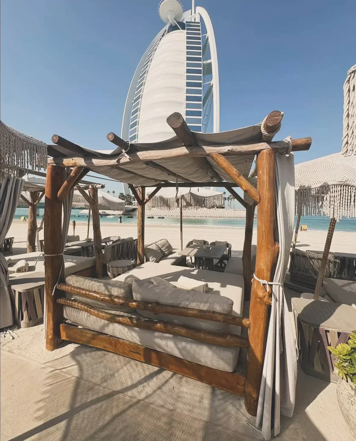 Verde Beach Dubai's luxurious beach cabana with Burj Al Arab in the background