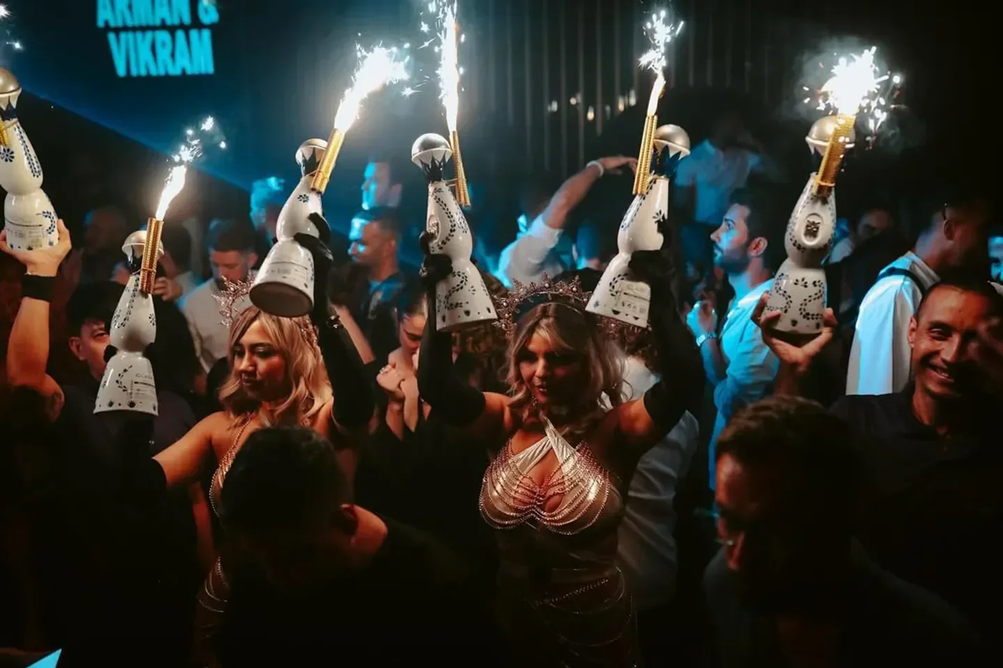 Sparkling bottles raised high at Vii nightclub in Dubai, creating a festive atmosphere.