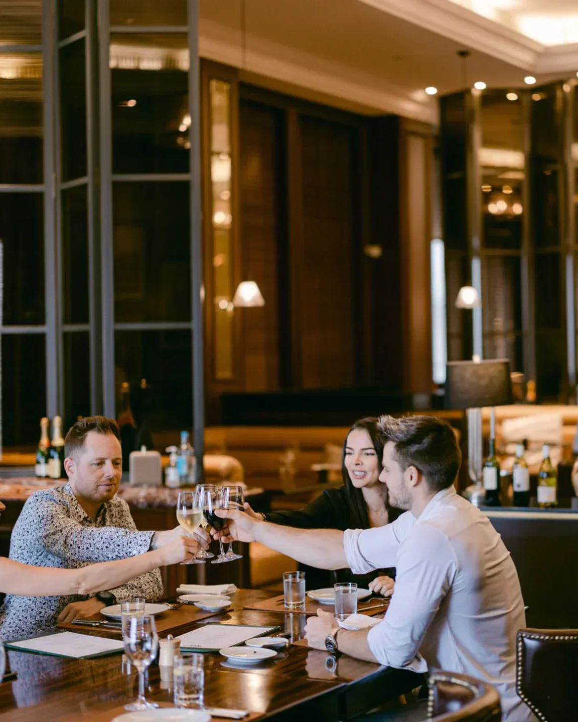 Cheers at World Cut Steakhouse Dubai: diners toasting wine at a fancy restaurant