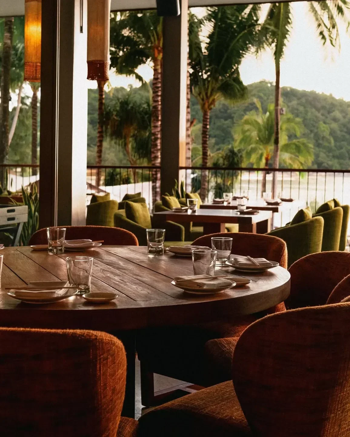 Dining area at Zuma Dubai, featuring round tables with sunset views